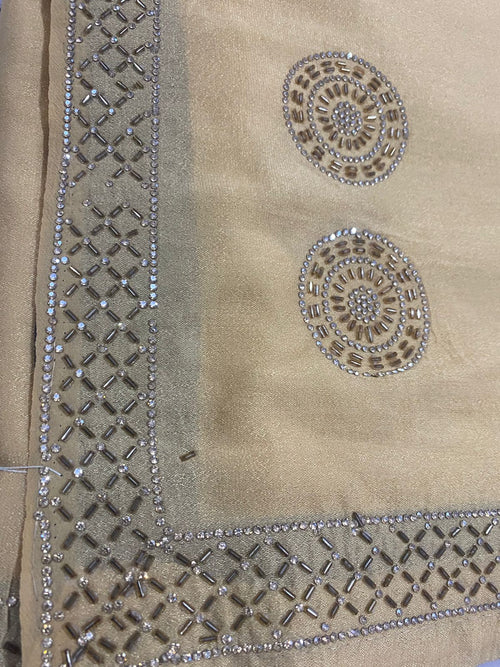 Beige saree with intricate work bread