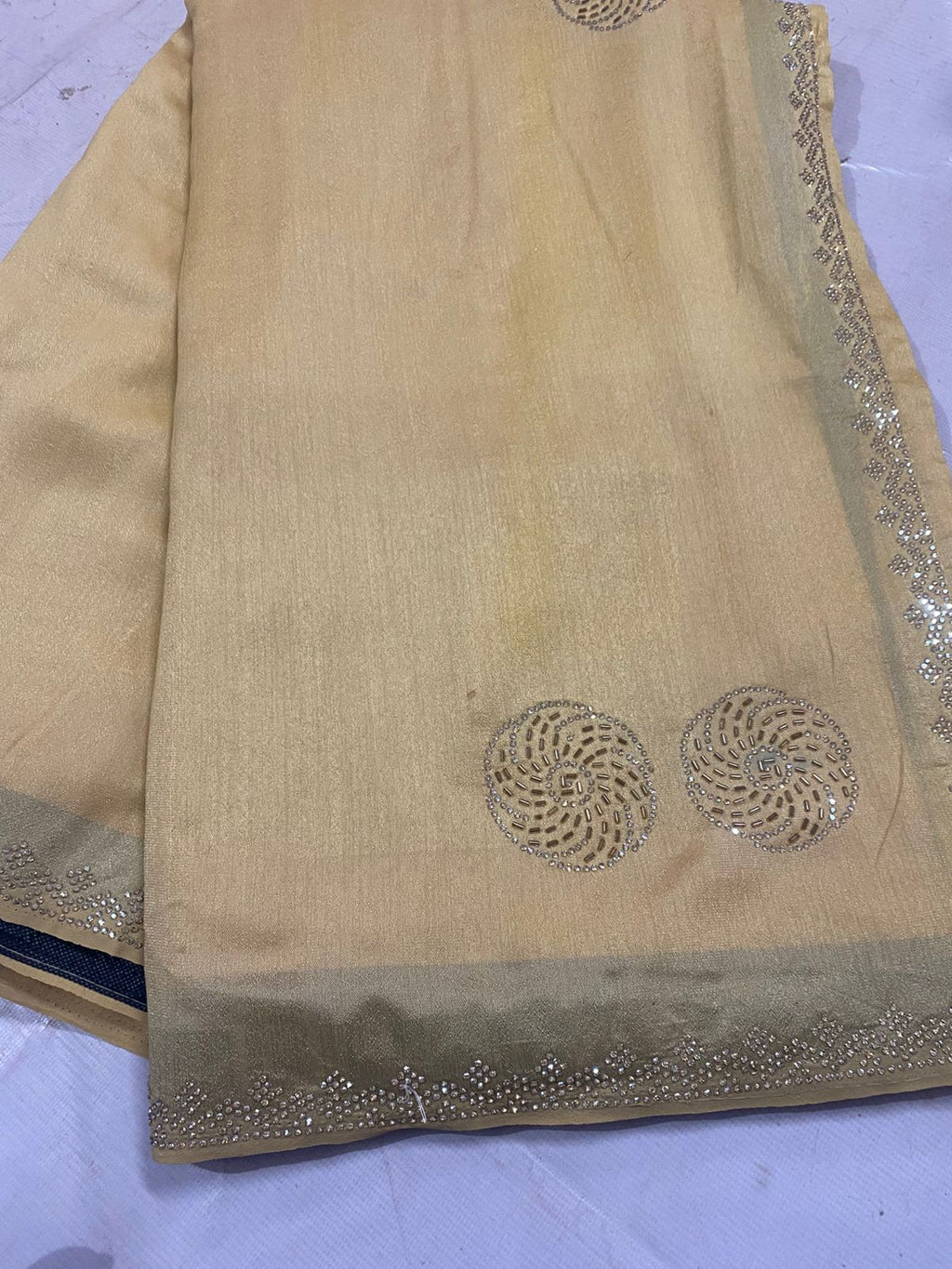 Beige saree with intricate work bread
