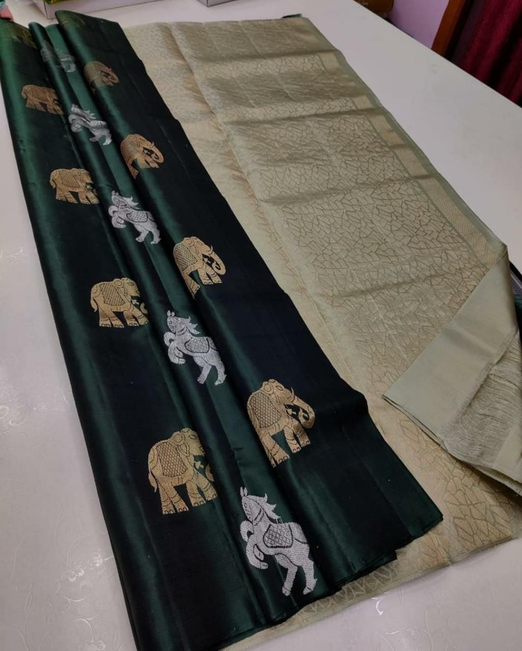 The silver zari (thread work) motifs of horses and elephantssilk saree