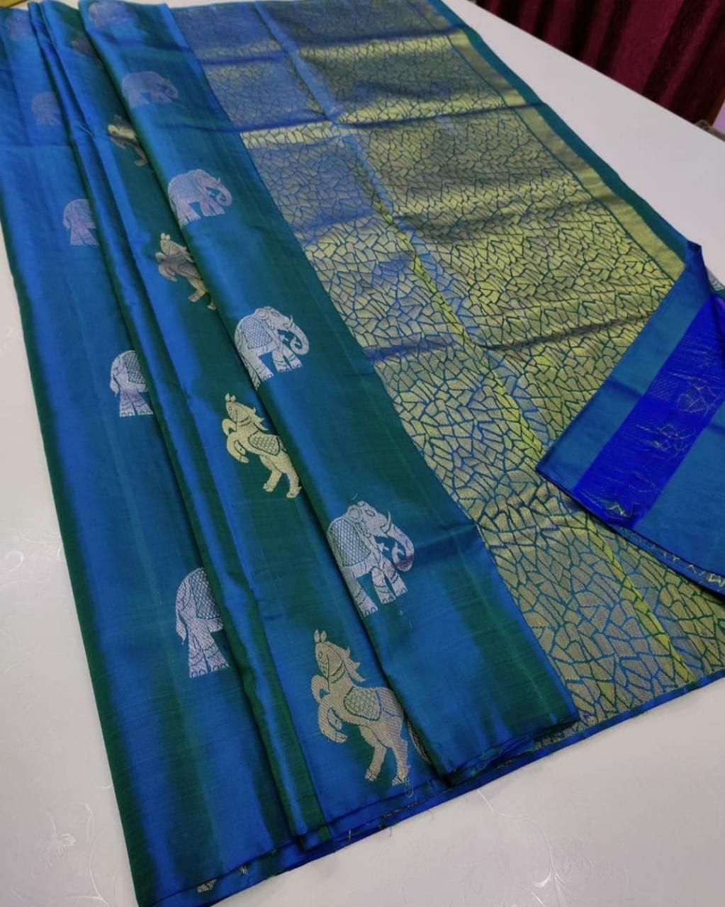 The silver zari (thread work) motifs of horses and elephantssilk saree