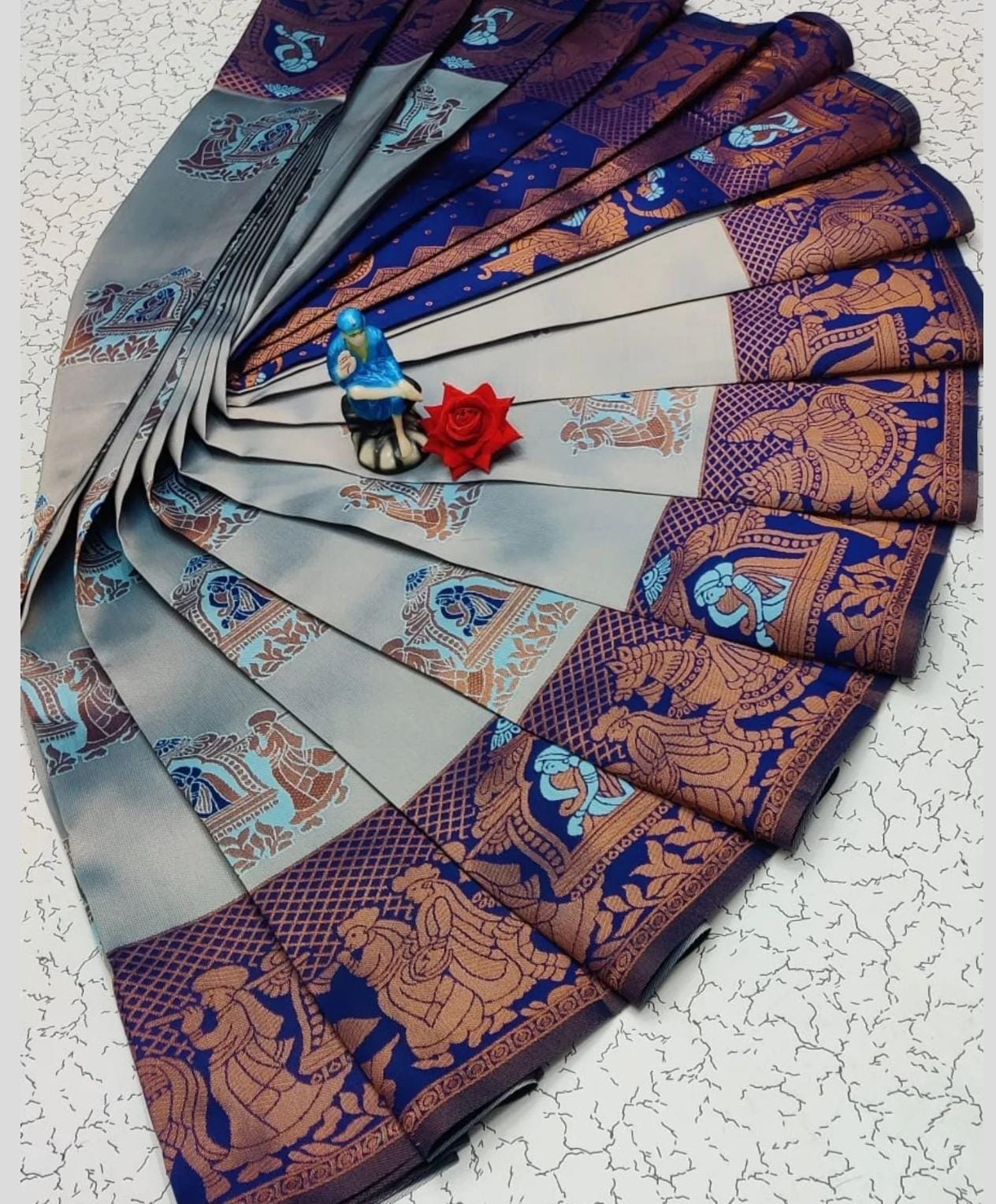 Fanned-out traditional saree with intricate patterns 